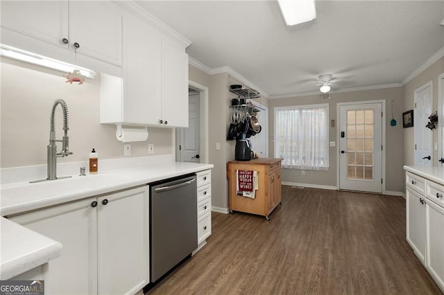 kitchen featuring a ceiling fan, dark wood-type flooring, white cabinets, stainless steel dishwasher, and crown molding