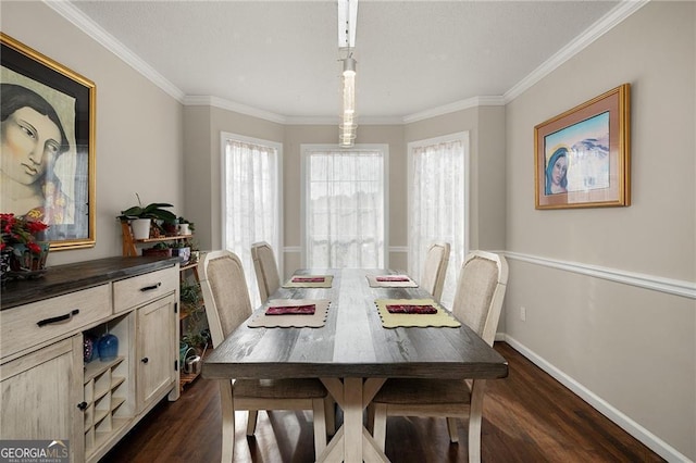 dining space featuring dark wood-type flooring, crown molding, and baseboards