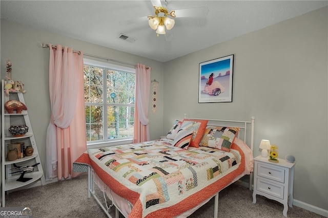 bedroom with visible vents, baseboards, ceiling fan, and carpet flooring