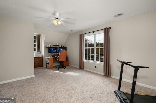 carpeted home office featuring visible vents, baseboards, and ceiling fan