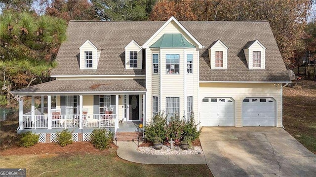 view of front of house featuring a shingled roof, covered porch, driveway, and a garage