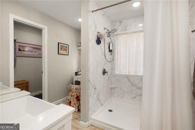 full bathroom with vanity, a shower with curtain, and baseboards