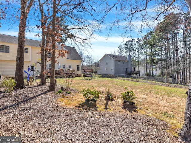 view of yard with a wooden deck and fence