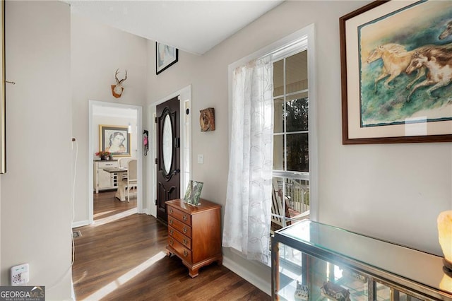 hallway with dark wood-style floors and baseboards