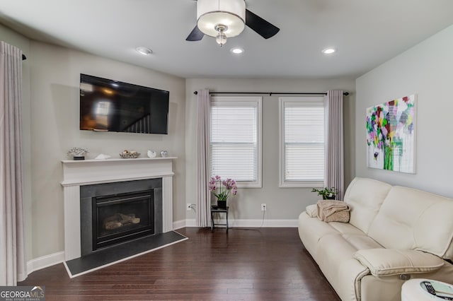 living room with ceiling fan and dark wood-type flooring