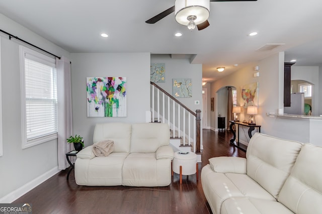 living room featuring dark hardwood / wood-style floors and ceiling fan