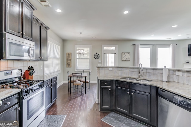 kitchen with dark hardwood / wood-style floors, stainless steel appliances, a wealth of natural light, and sink