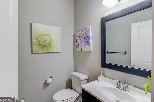 bathroom featuring vanity and toilet