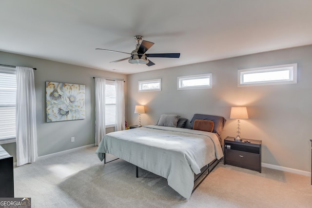 bedroom featuring light colored carpet and ceiling fan