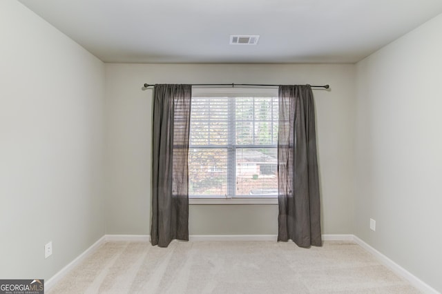 unfurnished room with light carpet