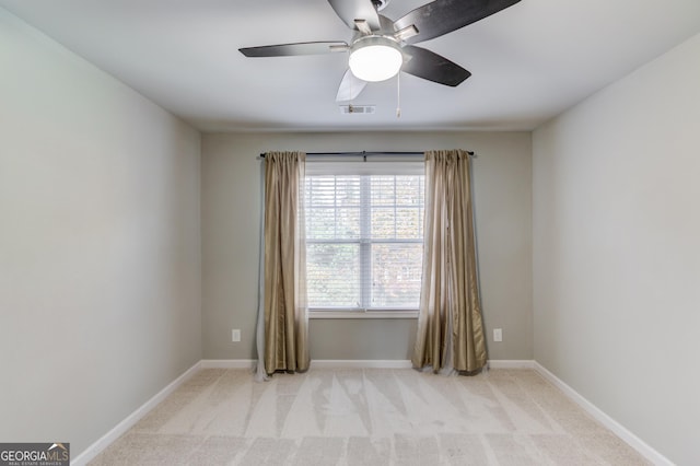 carpeted spare room featuring ceiling fan