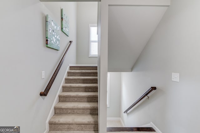 stairway with vaulted ceiling