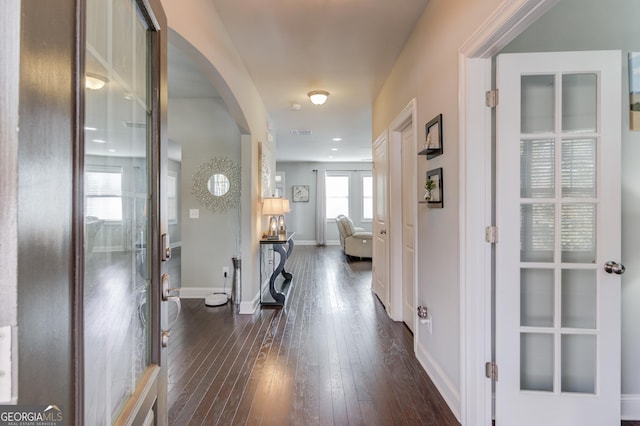 hall with dark wood-type flooring and french doors