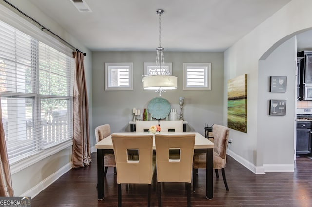 dining space with dark hardwood / wood-style flooring