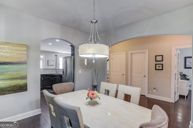 dining room with dark hardwood / wood-style floors and sink