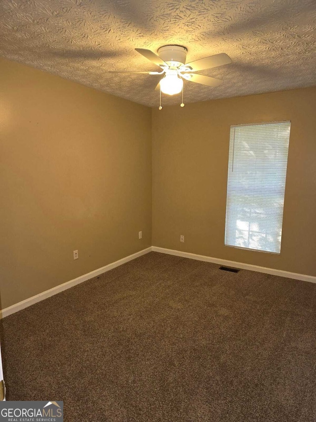 unfurnished room featuring carpet, ceiling fan, and a textured ceiling