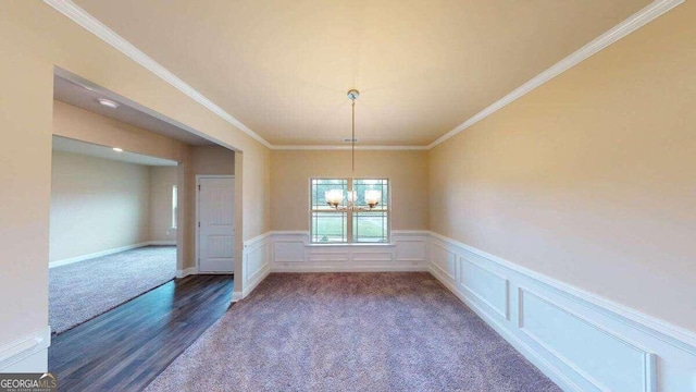 unfurnished dining area with a chandelier, crown molding, and dark wood-type flooring