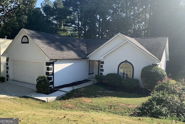 single story home featuring a front yard and a garage