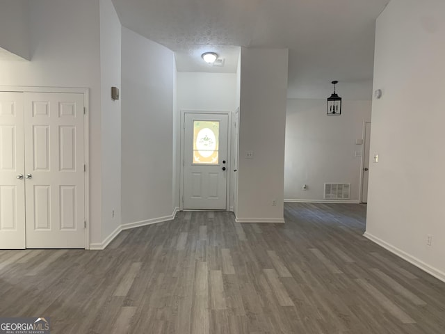 entryway with wood-type flooring and a textured ceiling