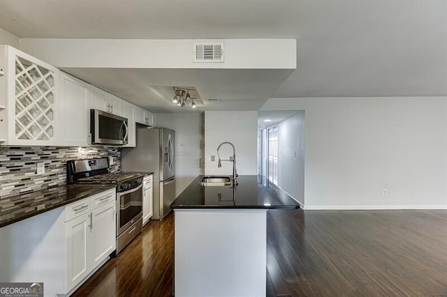 kitchen featuring appliances with stainless steel finishes, white cabinetry, dark wood-type flooring, and sink