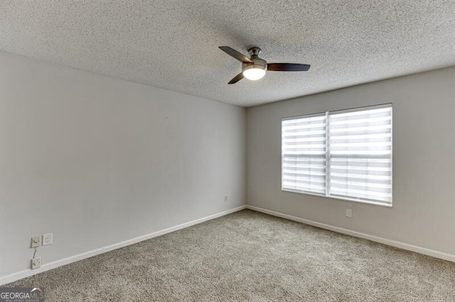 carpeted empty room with a textured ceiling and ceiling fan