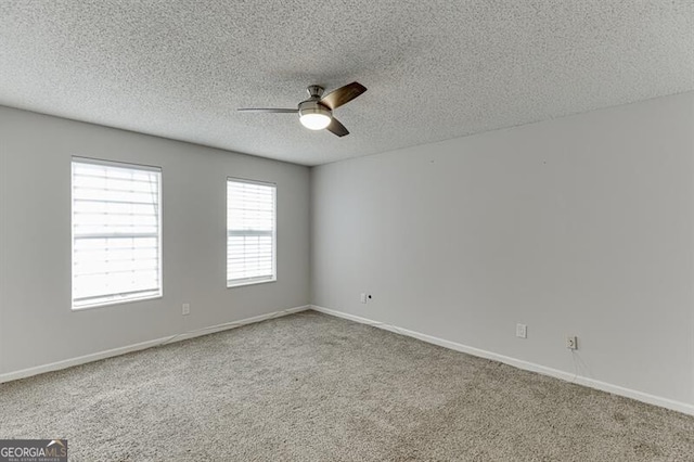 spare room featuring a textured ceiling, carpet floors, and ceiling fan