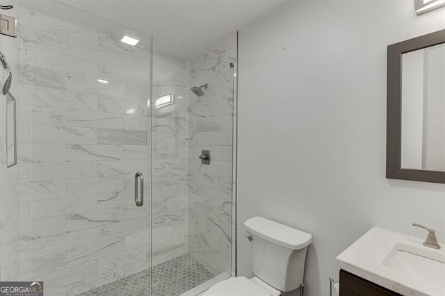 bathroom featuring vanity, toilet, and an enclosed shower