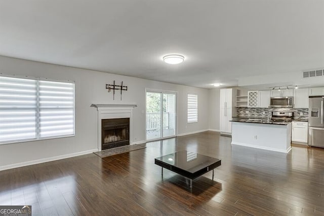 unfurnished living room with dark hardwood / wood-style floors