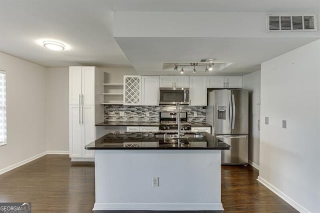 kitchen with dark wood-type flooring, sink, decorative backsplash, appliances with stainless steel finishes, and white cabinetry