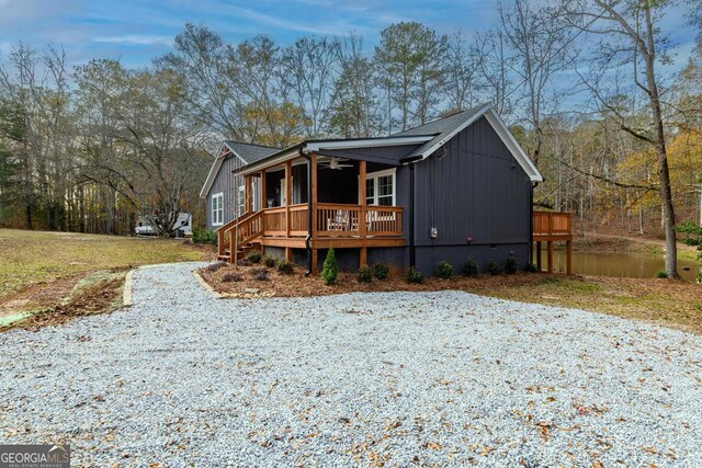 view of front of property featuring a deck with water view