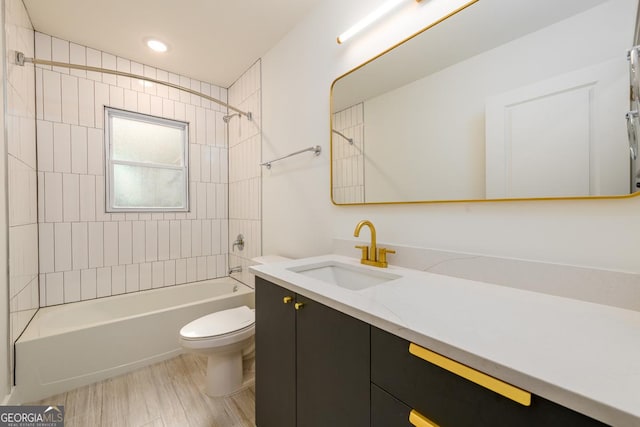 full bathroom with vanity, toilet, wood-type flooring, and tiled shower / bath