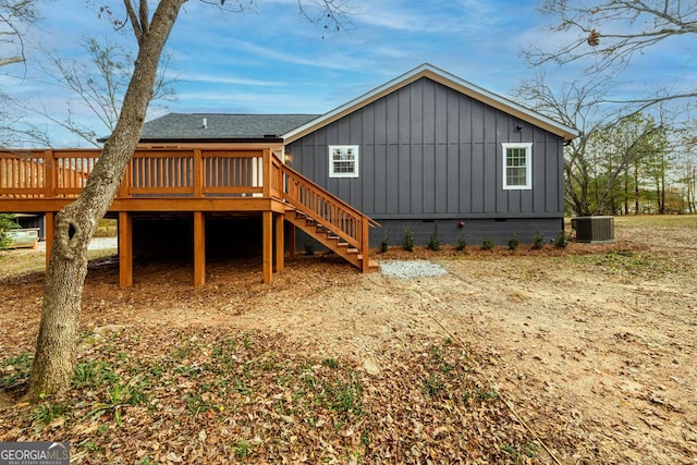 back of house featuring cooling unit and a wooden deck