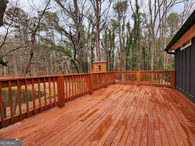 back of house featuring a deck and central air condition unit