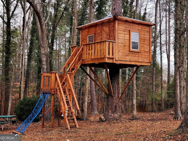 back of property with a wooden deck