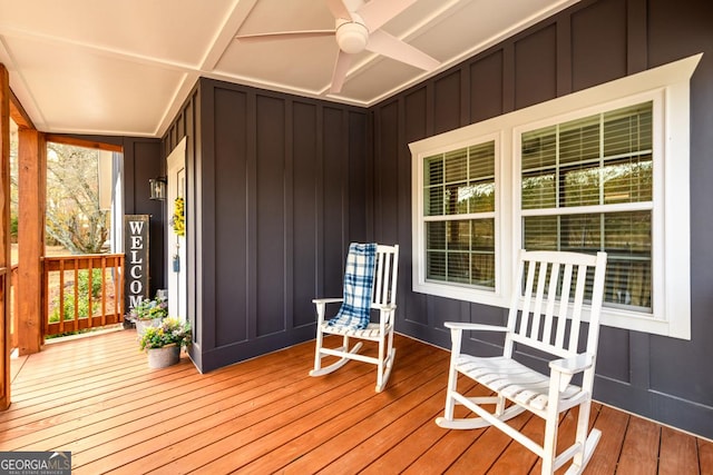 wooden terrace featuring a porch and ceiling fan