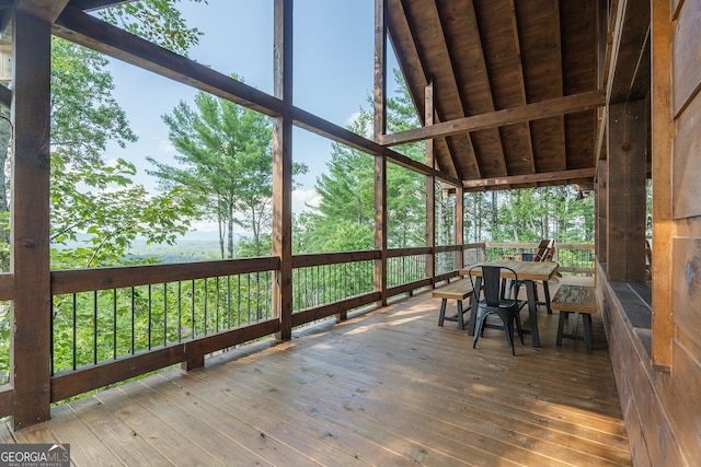 unfurnished sunroom with vaulted ceiling