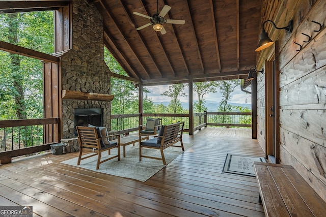 wooden deck featuring an outdoor living space with a fireplace and ceiling fan