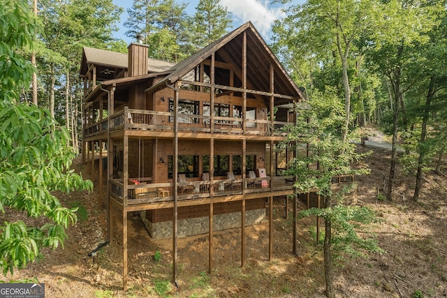 rear view of property featuring a deck