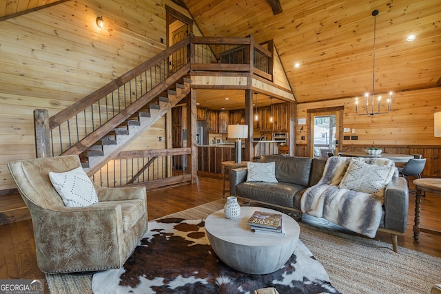 living room featuring wood ceiling, an inviting chandelier, high vaulted ceiling, dark hardwood / wood-style floors, and wood walls