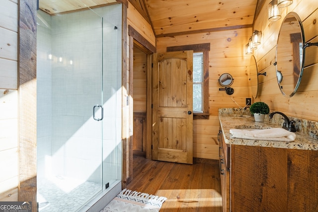 bathroom with wooden ceiling, wood walls, hardwood / wood-style floors, an enclosed shower, and vanity