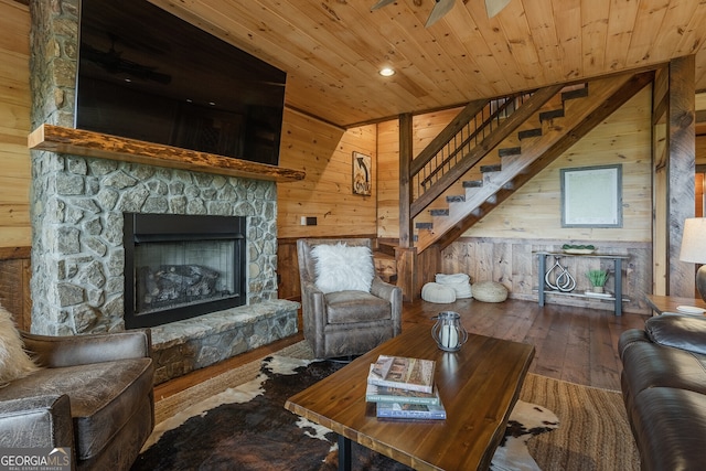 living room featuring hardwood / wood-style floors, wooden ceiling, and wooden walls