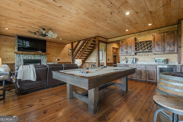 recreation room featuring wood walls, dark hardwood / wood-style flooring, wooden ceiling, and billiards