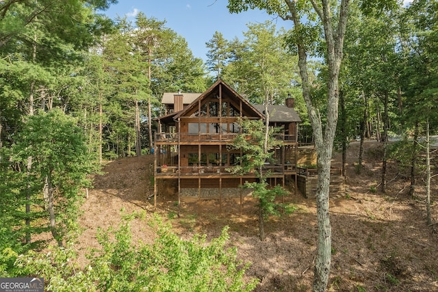 rear view of property featuring a deck