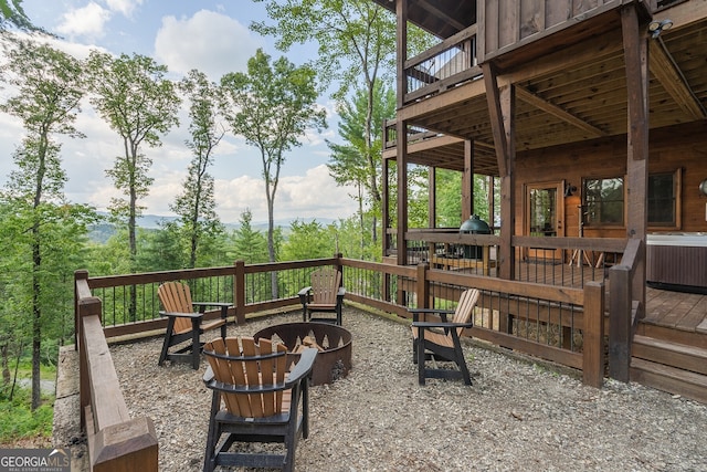 view of patio / terrace with central AC, a fire pit, and a deck