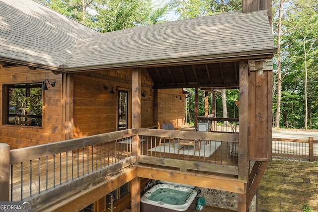 wooden deck featuring a hot tub