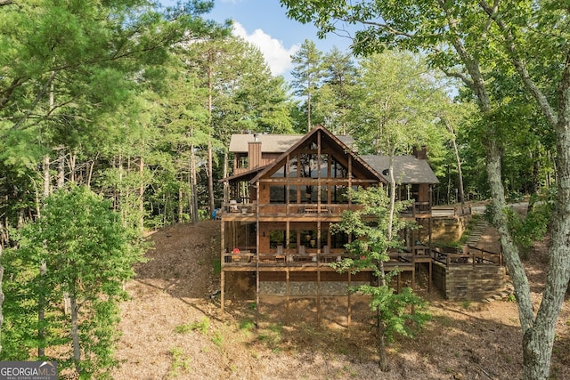 back of house featuring a deck