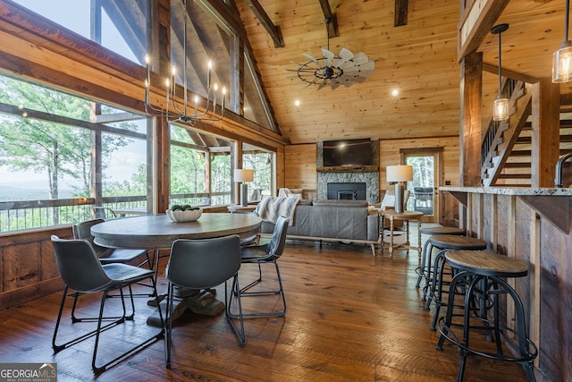 dining area featuring dark hardwood / wood-style flooring, high vaulted ceiling, and a healthy amount of sunlight