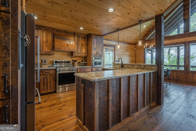 kitchen featuring sink, dark wood-type flooring, stainless steel appliances, lofted ceiling, and wood ceiling