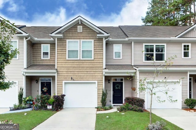 view of property with a front lawn and a garage