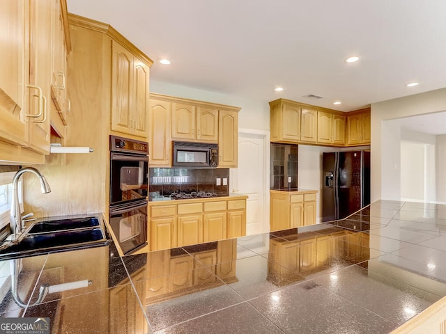 kitchen with black appliances, light brown cabinets, and sink